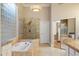 Luxurious bathroom featuring a large tub, glass-enclosed shower, and high-end finishes at 1507 E Treasure Cove Dr, Gilbert, AZ 85234