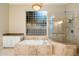 Gorgeous bathroom with garden tub, walk-in shower and window with natural light at 1507 E Treasure Cove Dr, Gilbert, AZ 85234