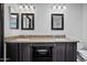 Bathroom with granite counters, dual sinks, and dark wood cabinets at 16044 S 41St Pl, Phoenix, AZ 85048