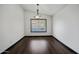 Dining room features a large window, hardwood floors and modern lighting at 16044 S 41St Pl, Phoenix, AZ 85048
