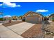 Charming single-story home with a two-car garage, desert landscaping, and a concrete driveway at 16044 S 41St Pl, Phoenix, AZ 85048