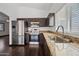 Modern kitchen featuring stainless steel appliances, dark wood cabinets and granite countertops at 16044 S 41St Pl, Phoenix, AZ 85048