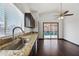 Kitchen features granite countertops, stainless steel sink and a sliding glass door to the backyard at 16044 S 41St Pl, Phoenix, AZ 85048
