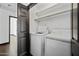 A dedicated laundry room featuring a washer, dryer, and storage shelving at 16044 S 41St Pl, Phoenix, AZ 85048