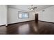 An open concept living room featuring dark wood floors, large windows, and a front door at 16044 S 41St Pl, Phoenix, AZ 85048
