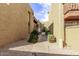 Exterior walkway featuring mature landscaping and gravel beds between buildings at 1701 W Tuckey Ln # 231, Phoenix, AZ 85015