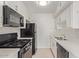 Bright kitchen features white cabinets, subway tile backsplash, and stainless steel appliances at 1701 W Tuckey Ln # 231, Phoenix, AZ 85015