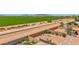 Expansive aerial view of the property showcasing its spacious backyard, landscaping, and canal access at 17418 N Carmen Ave, Maricopa, AZ 85139