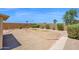 Large backyard featuring mature desert landscaping, stone walkways, and block fencing at 17418 N Carmen Ave, Maricopa, AZ 85139