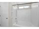 Clean bathroom features a shower with a built-in seat and grab bar, as well as an adjustable shower head at 17418 N Carmen Ave, Maricopa, AZ 85139