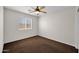 Cozy bedroom with a ceiling fan and window providing lots of natural light at 17418 N Carmen Ave, Maricopa, AZ 85139