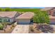 Exterior shot of a home featuring a well-manicured lawn and spacious driveway at 17418 N Carmen Ave, Maricopa, AZ 85139