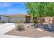 Charming single-story home with a low-maintenance desert landscape and a welcoming front entrance at 17418 N Carmen Ave, Maricopa, AZ 85139