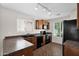 Kitchen featuring ample natural light, track lighting, dark appliances, and breakfast bar at 17418 N Carmen Ave, Maricopa, AZ 85139