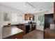 A well-lit kitchen is equipped with dark countertops and modern appliances at 17418 N Carmen Ave, Maricopa, AZ 85139