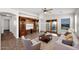 Bright living room with elegant built-ins, neutral walls, and a ceiling fan at 17418 N Carmen Ave, Maricopa, AZ 85139