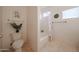 Well-lit bathroom featuring a toilet and shower tub combination, with decorative plants at 1750 W Union Hills Dr # 8, Phoenix, AZ 85027