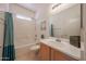 Bright bathroom with a single sink vanity, a bathtub-shower combination and decorative accents at 1750 W Union Hills Dr # 8, Phoenix, AZ 85027