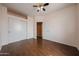 Bright bedroom features wood floors, ceiling fan, and ample closet space at 1750 W Union Hills Dr # 8, Phoenix, AZ 85027