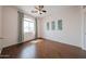 Bright, airy bedroom featuring wood floors, large window with decorative curtains and artwork at 1750 W Union Hills Dr # 8, Phoenix, AZ 85027