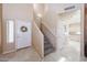 Inviting entryway with tile floors, a staircase, and a decorated front door at 1750 W Union Hills Dr # 8, Phoenix, AZ 85027