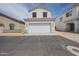 Two-story home featuring a two-car garage, red tile roof, and manicured front yard at 1750 W Union Hills Dr # 8, Phoenix, AZ 85027