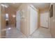 Hallway with neutral paint, tile floors, closet storage, and nearby staircase at 1750 W Union Hills Dr # 8, Phoenix, AZ 85027