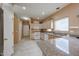 Well-lit kitchen with granite countertops, wooden cabinetry, and tile flooring at 1750 W Union Hills Dr # 8, Phoenix, AZ 85027
