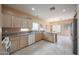 Bright kitchen with wooden cabinets, granite countertops, and modern appliances at 1750 W Union Hills Dr # 8, Phoenix, AZ 85027