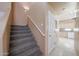 Carpeted staircase leads to the upper level with a neutral color palette and access to the kitchen at 1750 W Union Hills Dr # 8, Phoenix, AZ 85027
