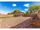 Spacious backyard with gravel landscaping, a covered patio, and a lush lawn area, perfect for outdoor enjoyment at 18417 W Elm St, Goodyear, AZ 85395