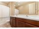 This bathroom features a double sink vanity, shower/tub combo, and neutral walls at 18417 W Elm St, Goodyear, AZ 85395