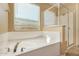 Bright bathroom with soaking tub and walk-in shower at 18417 W Elm St, Goodyear, AZ 85395