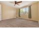 Spacious bedroom featuring a ceiling fan and large window at 18417 W Elm St, Goodyear, AZ 85395