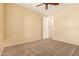 This carpeted bedroom includes a ceiling fan, neutral walls, and access to a closet at 18417 W Elm St, Goodyear, AZ 85395