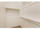 This walk-in closet has neutral walls, carpet, and shelving for optimal storage at 18417 W Elm St, Goodyear, AZ 85395