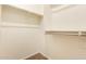 This walk-in closet has neutral walls, carpet, and shelving for optimal storage at 18417 W Elm St, Goodyear, AZ 85395