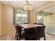 Dining room features a stylish light fixture, neutral walls, and access to the outdoor patio at 18417 W Elm St, Goodyear, AZ 85395