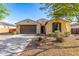 Inviting single-story home featuring a desert landscape, and a two-car garage at 18417 W Elm St, Goodyear, AZ 85395