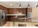 Stylish kitchen featuring dark cabinets, stainless steel appliances, and granite countertops at 18417 W Elm St, Goodyear, AZ 85395