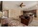 Open living room showcasing tile flooring, a ceiling fan, and seamless flow into the kitchen at 18417 W Elm St, Goodyear, AZ 85395