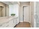 Bright bathroom with stone counters, double vanity, and white cabinets with storage at 2 Biltmore Est # 309, Phoenix, AZ 85016