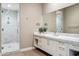 Modern bathroom features a large marble walk-in shower and sleek vanity with lots of counter space at 2 Biltmore Est # 309, Phoenix, AZ 85016