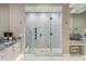 Luxurious bathroom showcasing a glass-enclosed shower, marble countertops, and dual sink vanities at 2 Biltmore Est # 309, Phoenix, AZ 85016
