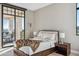 Inviting bedroom boasts natural light, refined decor, and access to an outdoor terrace at 2 Biltmore Est # 309, Phoenix, AZ 85016