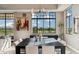 Elegant dining room with modern chandelier, large window view, and stylish decor at 2 Biltmore Est # 309, Phoenix, AZ 85016