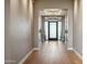 Grand foyer with hardwood flooring, elegant chandelier, and frosted glass front door at 2 Biltmore Est # 309, Phoenix, AZ 85016