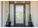Contemporary front entrance with sleek glass door, modern accents, and manicured landscaping at 2 Biltmore Est # 309, Phoenix, AZ 85016