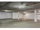 Spacious and well-lit parking garage with painted support beams, concrete ceiling and flooring at 2 Biltmore Est # 309, Phoenix, AZ 85016