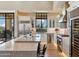 Well-appointed kitchen with island, custom cabinetry, professional grade appliances, and natural light at 2 Biltmore Est # 309, Phoenix, AZ 85016